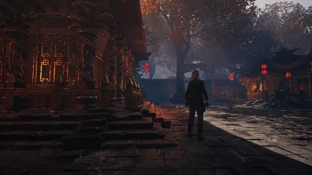 A Far Eastern temple courtyard lit by red lanterns
